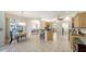 Spacious kitchen with a breakfast nook and island barstool seating in an open floor plan at 129 Wayforest Dr, Venice, FL 34292