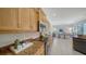 Charming kitchen with wooden cabinetry, granite countertops, and stainless steel appliances at 129 Wayforest Dr, Venice, FL 34292