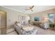 Comfortable living room with a ceiling fan, modern décor, and lots of natural light at 129 Wayforest Dr, Venice, FL 34292