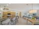 Open-concept living space featuring kitchen with bar seating and a comfortable lounge area at 129 Wayforest Dr, Venice, FL 34292