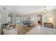 Spacious living room with stylish furniture, hardwood floors, and seamless access to the outdoors at 129 Wayforest Dr, Venice, FL 34292
