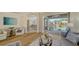 Open living area showcases wood floors and seamless access to the screened pool area at 129 Wayforest Dr, Venice, FL 34292