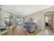 Inviting living room featuring hardwood floors, neutral decor, and a view of the outdoor pool area at 129 Wayforest Dr, Venice, FL 34292