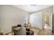 Home office with a desk, neutral decor, wood floors and a view of the hallway at 129 Wayforest Dr, Venice, FL 34292
