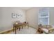 Bright home office featuring a desk, neutral decor, wood floors and a large window at 129 Wayforest Dr, Venice, FL 34292