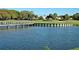 Scenic pond view showcases a bridge and lush landscaping, enhancing the community's natural beauty and charm at 129 Wayforest Dr, Venice, FL 34292