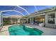 Inviting screened-in pool area with covered lanai, brick patio, and comfortable lounge seating at 129 Wayforest Dr, Venice, FL 34292