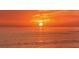 Spectacular sunset view over the ocean, casting a warm, golden glow across the water and sky at 129 Wayforest Dr, Venice, FL 34292