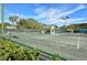 Well-maintained tennis courts amidst a green landscape offer an active lifestyle within this beautiful community at 129 Wayforest Dr, Venice, FL 34292