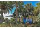 Welcome to Venice Beach sign amongst the lush palm trees and greenery of the shoreline at 129 Wayforest Dr, Venice, FL 34292