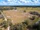 Aerial view of vast land with fencing, green trees, and pasture for horses at 15101 Rawls Rd, Sarasota, FL 34240