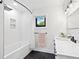Elegant bathroom featuring a soaking tub, modern fixtures, and stylish black hexagon tile flooring at 15101 Rawls Rd, Sarasota, FL 34240