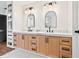 Bathroom featuring a double sink vanity with wood cabinetry, marble countertops, and modern fixtures at 15101 Rawls Rd, Sarasota, FL 34240