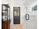 Bathroom showcasing a walk-in shower, brick floors, wood cabinet and a black-framed glass door at 15101 Rawls Rd, Sarasota, FL 34240