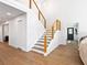 Spacious entryway features modern staircase with wooden handrails, and hardwood floors at 15101 Rawls Rd, Sarasota, FL 34240