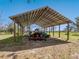Open air equipment storage featuring a tractor, boat and other equipment at 15101 Rawls Rd, Sarasota, FL 34240