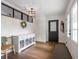Bright foyer with hardwood floors, white wainscoting, and a decorative chandelier at 15101 Rawls Rd, Sarasota, FL 34240