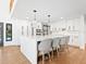 Bright modern kitchen with white cabinets, quartz countertop island, stainless steel appliances and hardwood floors at 15101 Rawls Rd, Sarasota, FL 34240