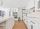 Modern kitchen features white cabinets, stainless steel appliances, a central island and hardwood floors at 15101 Rawls Rd, Sarasota, FL 34240