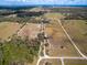 Aerial view of a large parcel of land with fenced pastures and wooded areas, surrounded by a white boundary at 15101 Rawls Rd, Sarasota, FL 34240