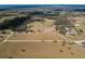 Aerial view of a property featuring fenced pastures and open land, defined by a white boundary line at 15101 Rawls Rd, Sarasota, FL 34240
