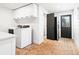 Laundry room featuring a washer and dryer and a black door that leads outside at 15101 Rawls Rd, Sarasota, FL 34240