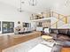 Open floor plan with dining area, living room with a leather couch, modern staircase, and kitchen at 15101 Rawls Rd, Sarasota, FL 34240