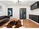Cozy living room with hardwood floors, a stylish cowhide rug, and sleek black cabinets at 15101 Rawls Rd, Sarasota, FL 34240