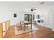 Home office with hardwood floors, ceiling fan, desk with a bench, built in shelves, and cabinets at 15101 Rawls Rd, Sarasota, FL 34240