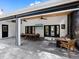 Outdoor living space with a dining table, ceiling fans, and a lounge area at 15101 Rawls Rd, Sarasota, FL 34240