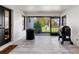 Sunroom featuring tile floors, large windows, and a view of the backyard and lawn at 15101 Rawls Rd, Sarasota, FL 34240