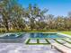 Swimming pool in the backyard of the property with trees and lounge chairs around the pool at 15101 Rawls Rd, Sarasota, FL 34240