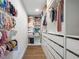 Bright walk-in closet with custom shelving and storage for clothes and personal items at 15101 Rawls Rd, Sarasota, FL 34240