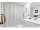 Clean bathroom with white fixtures, a shower with curtain, and essential amenities for a functional space at 1519 Pelican Point Dr # 288, Sarasota, FL 34231
