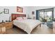 Serene bedroom featuring a king-size bed, soft lighting, and access to a private balcony for relaxation at 1519 Pelican Point Dr # 288, Sarasota, FL 34231