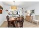 Inviting dining room with wood table, seating for six, and stylish light fixture, creating an ideal space for gatherings at 1519 Pelican Point Dr # 288, Sarasota, FL 34231