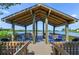 Beautiful lakeside gazebo with seating, perfect for enjoying the scenic water views and peaceful surroundings at 1519 Pelican Point Dr # 288, Sarasota, FL 34231