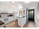 Bright kitchen features white cabinetry, granite countertops, stainless appliances, and access to an outdoor balcony at 1519 Pelican Point Dr # 288, Sarasota, FL 34231
