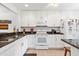 Modern kitchen with white cabinets, granite counters, a sleek range, and stainless steel appliances for cooking at 1519 Pelican Point Dr # 288, Sarasota, FL 34231