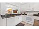 Clean kitchen features white cabinetry, granite countertops, stainless appliances, and an open floor plan design at 1519 Pelican Point Dr # 288, Sarasota, FL 34231