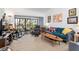 Inviting living room with plush seating, warm accents, and access to a screened-in balcony with views at 1519 Pelican Point Dr # 288, Sarasota, FL 34231
