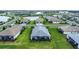 Aerial view of a home with a screened-in patio and lush green lawn in a well-planned community at 16111 Sunny Day Dr, Bradenton, FL 34211