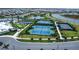 Aerial view of the community recreational area featuring tennis courts, basketball courts, and walking paths at 16111 Sunny Day Dr, Bradenton, FL 34211