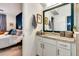 Bathroom vanity featuring granite countertops, modern fixtures, framed mirror, and access to the primary bedroom at 16111 Sunny Day Dr, Bradenton, FL 34211