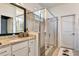 Bathroom vanity featuring granite countertops, modern fixtures, framed mirror, and access to the glass enclosed shower at 16111 Sunny Day Dr, Bradenton, FL 34211