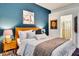 Tastefully decorated bedroom with a blue accent wall, modern furnishings, and access to the en-suite bathroom at 16111 Sunny Day Dr, Bradenton, FL 34211