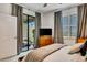 Comfortable bedroom featuring neutral walls, plush carpet, and access to the private outdoor patio at 16111 Sunny Day Dr, Bradenton, FL 34211