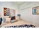 Bedroom with a neutral bed with lots of pillows and a colorful painting at 16111 Sunny Day Dr, Bradenton, FL 34211