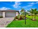 Charming home featuring a paved driveway, well-maintained lawn, and vibrant landscaping, perfect for curb appeal at 16111 Sunny Day Dr, Bradenton, FL 34211
