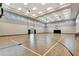 Indoor basketball court with hardwood floors, high ceilings, and ample natural light at 16111 Sunny Day Dr, Bradenton, FL 34211
